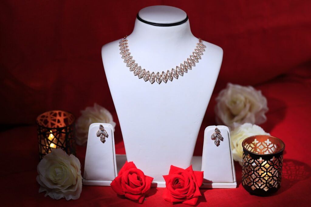 a white mannequin with red roses and jewelry on it